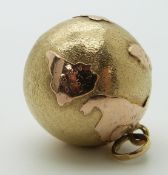 A yellow metal globe charm/ pendant, 7.1g