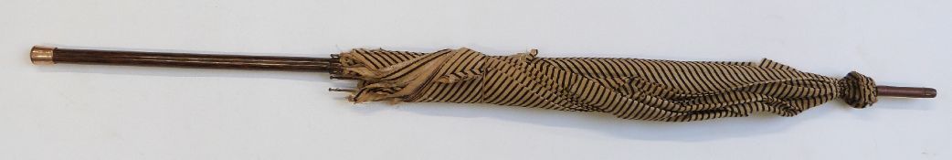 A late 19thC 20thC parasol with plated finial to handle/stick, probably zebra wood, 93cm