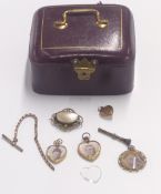 Three Victorian lockets, a section of yellow metal fob chain etc in a tooled leather jewellery box