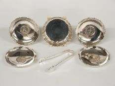 Five silver and white metal pin dishes, one with feature hallmarks to underside, the other four