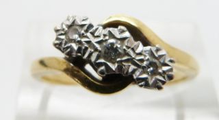 An 18ct gold ring set with three diamonds in a platinum illusion setting, size Q