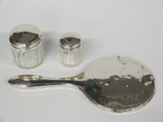 Hallmarked silver mounted hand mirror and two hallmarked silver lidded dressing table pots