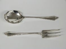 A pair of George V hallmarked silver salad servers with geometric Art Deco design to the bowl/tines,
