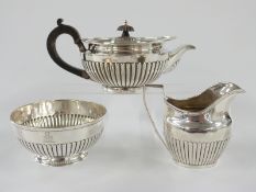 Victorian hallmarked silver tea set of squat lobed form, the boat shaped teapot London 1880, milk