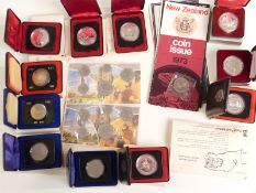 Eleven cased 1970's Canadian dollar coins together with a 1979 and 1981 set, Winnipeg Dollar etc