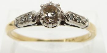 An 18ct gold ring set with a diamond of approximately 0.35ct in a platinum setting with diamond