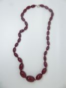 A cherry amber necklace made up of graduated oval beads, 30g