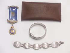 A hallmarked silver bracelet comprising five views of London, a silver bangle with chased decoration