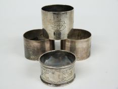 Four various hallmarked silver napkin rings including a pair of plain examples, weight 142g