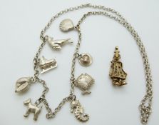 A 9ct gold charm in the form of a clown with articulated arms and legs, 4.5g and white metal charm