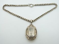 Victorian silver locket with engraved foliate design by W & Co, with chain