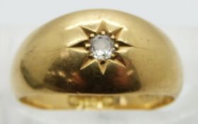 An 18ct gold ring set with a diamond
