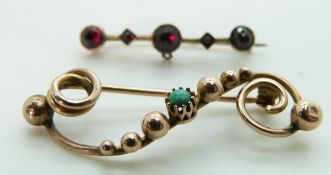 Victorian brooch set with a turquoise cabochon and a Victorian brooch set with garnets