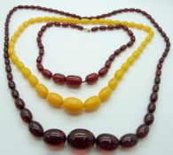 A cherry amber necklace and two amber style necklaces