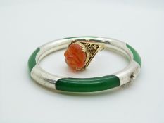 A silver and jadeite style bangle and silver gilt ring set with carved carnelian agate