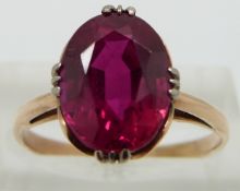 A 10ct gold ring set with an oval synthetic ruby, size Q