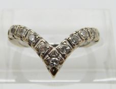 An 18ct white gold ring set with diamonds in a V shape, size I