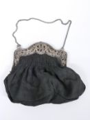 George V hallmarked silver mounted ladies evening bag with pierced and embossed floral and cherub