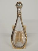 An 18th/19thC gilt white metal mounted glass tear drop shaped scent bottle, the lid set with eight