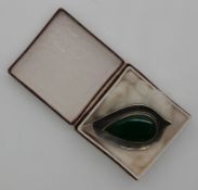 A silver brooch set with agate in the form of a stylised leaf