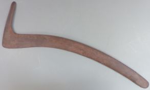 A 19thC Australian Aboriginal hunting boomerang or throwing stick with carved parallel lines and