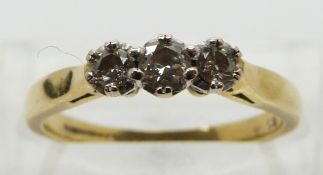 An 18ct gold ring set with three diamonds, total diamond weight approximately 0.25ct, size L