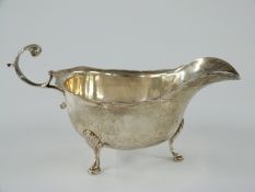 George V hallmarked silver sauce boat raised on three feet, Birmingham 1912 maker George Nathan &