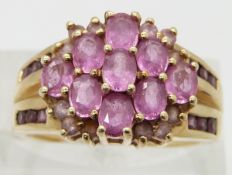 A 9ct gold ring set with pink sapphires, size P
