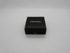 A pair of Chanel earrings in original box