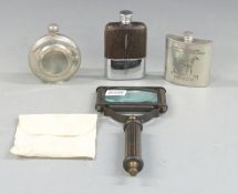 Three hip flasks and a magnifying glass