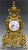 Louis XV style brass mantel clock the enamel Roman dial with filigree hands, the two train French