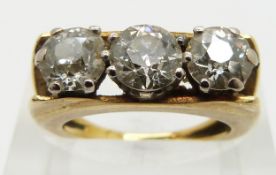 An 18ct gold ring set with three round cut diamonds each approximately 0.9, 0.7 and 0.7ct