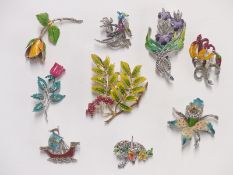 A collection of enamel and marcasite brooches, including Giovanni and Exquisite