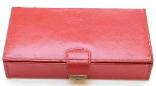 A red leather cased Bridge set including four hallmarked silver pencils mounted with playing