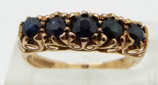 A 9ct gold ring set with five round cut sapphires, size K