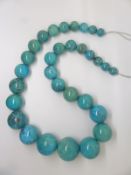 A large beaded turquoise necklace, largest bead 3cm, smallest bead 1cm