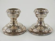 A pair of hallmarked silver squat candlesticks, Birmingham 1909 maker Henry Clifford Davis, height