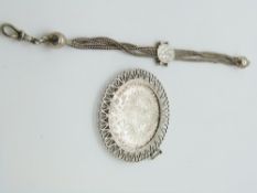 A white metal fob chain with three strands and a mounted Maria Theresia coin in a pendant mount