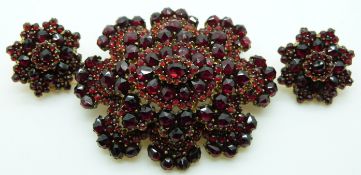Victorian brooch set with Bohemian cut garnets in a tiered setting, with matching earrings
