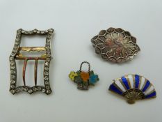 A Victorian silver brooch with applied gold detail, a silver Siam fan brooch set with enamel, a