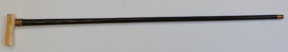 A 19thC walking cane with marine ivory handle and repoussé decorated collar marked 15ct G