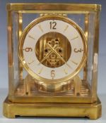 LeCoultre and Co Atmos clock, in brass case with white enamel chapter ring and alternate baton