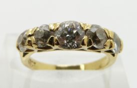 An 18ct gold ring set with five graduated round cut diamonds, the centre diamond approximately 0.