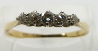 An 18ct gold ring set with five diamonds in a platinum setting, size Q