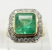 An 18ct gold ring set with an emerald cut emerald approximately 3.3ct surround by diamonds, size N
