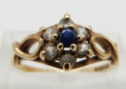 A 9ct gold ring set with a sapphire surrounded by paste, size N
