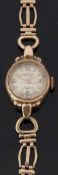 Accurist 9ct gold ladies wristwatch with gold hands and markers, sunburst dial and signed 21 jewel
