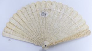 A 19thC Chinese carved ivory fan of 21 sticks each decorated with figural scenes to both sides,