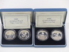 Two Royal Mint 1989 £2 silver proof two coin sets, in original cases