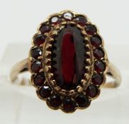 A 9ct gold ring set with garnets, size J